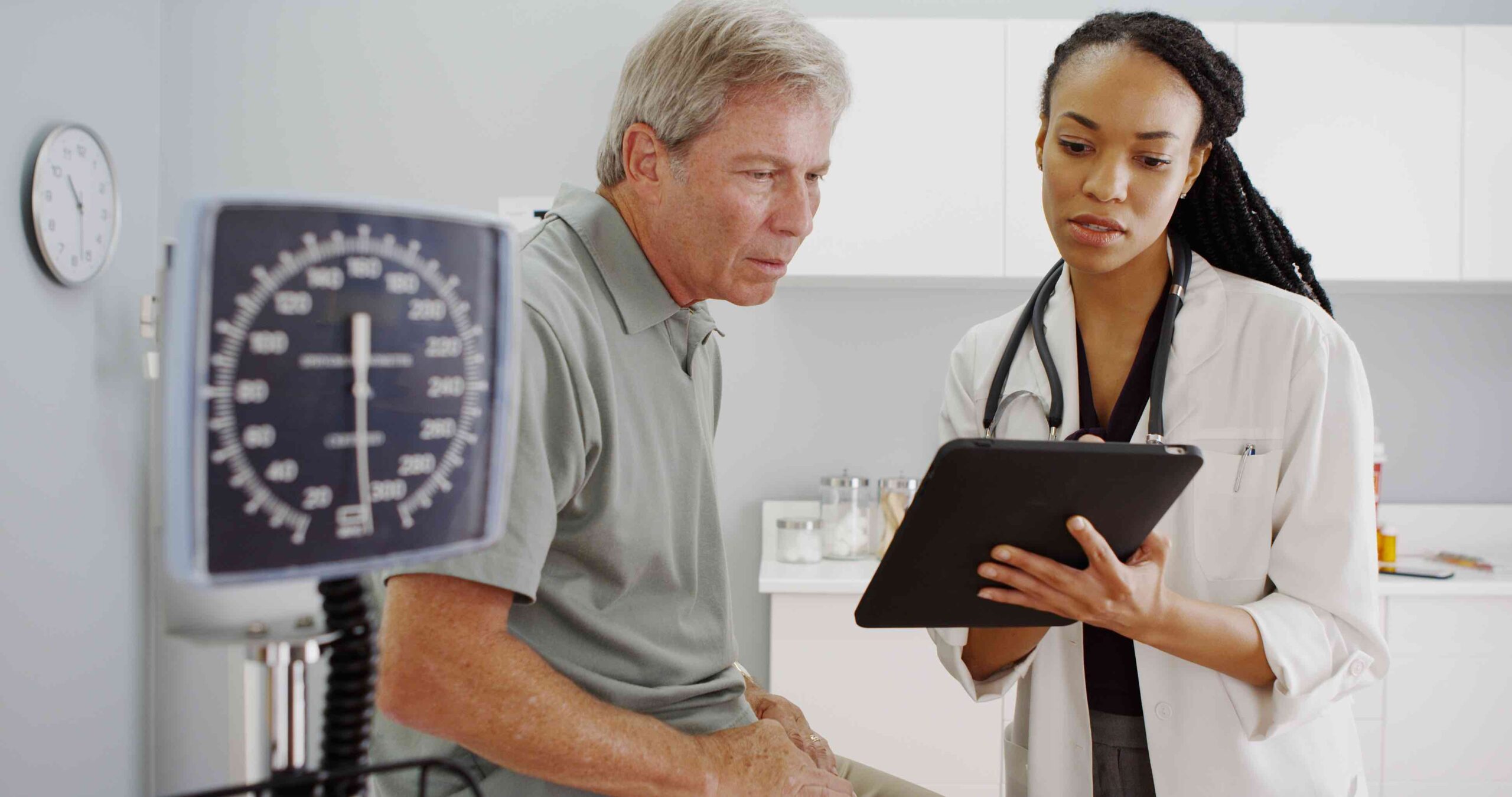 A doctor showing a man his chart.