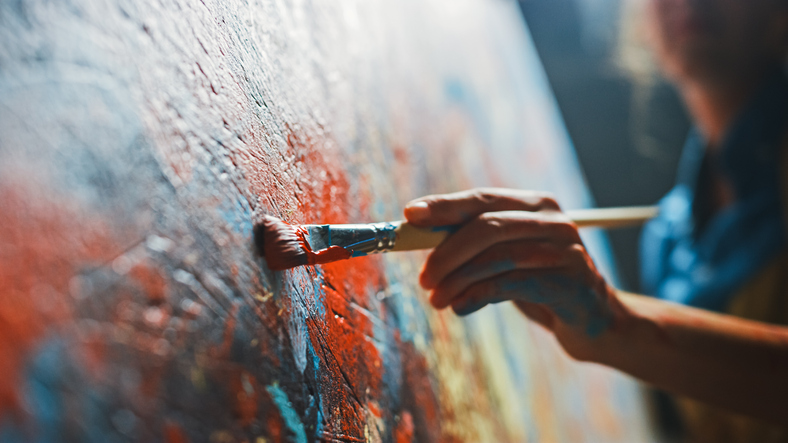 Art + specie 1 A female artist at work on an abstract oil painting.