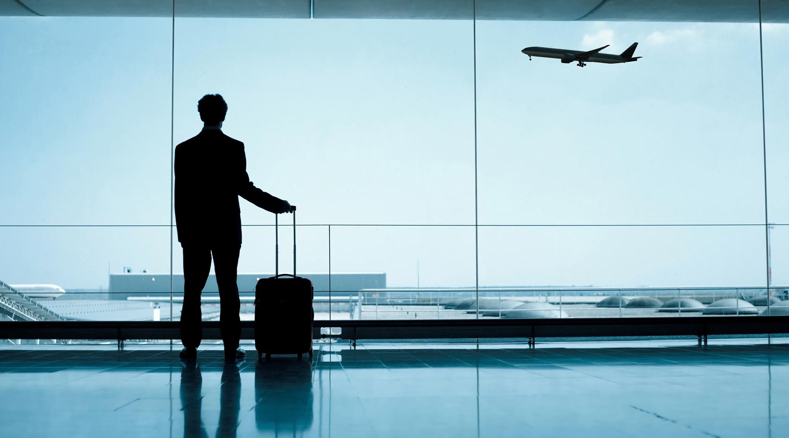 Benefits 6 A businessman inside an airport traveling.