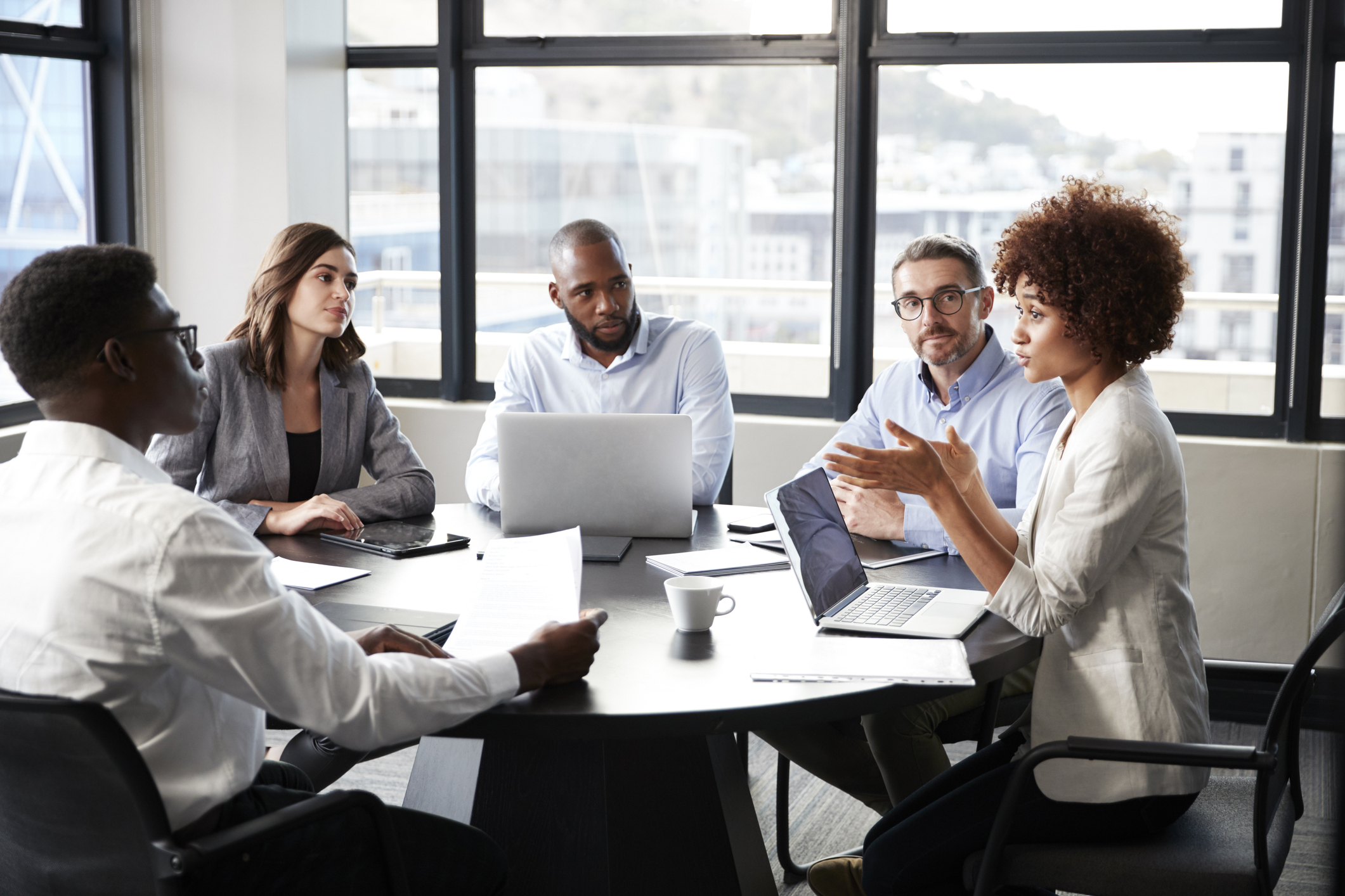 Appraisals under policy 2 Coworkers having a meeting in a conference room.
