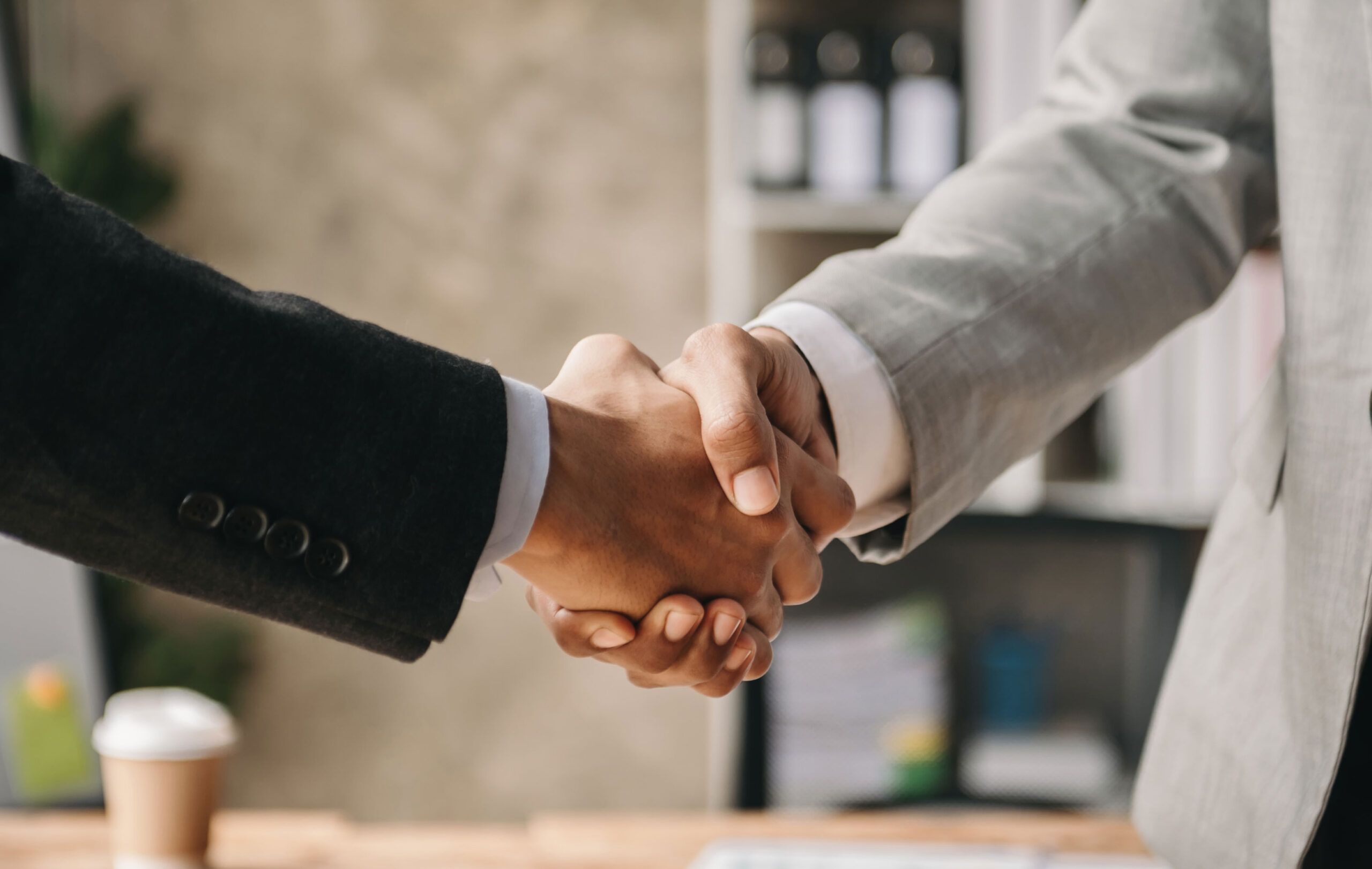 Consumer + Warranty 2 Two people shaking hands.