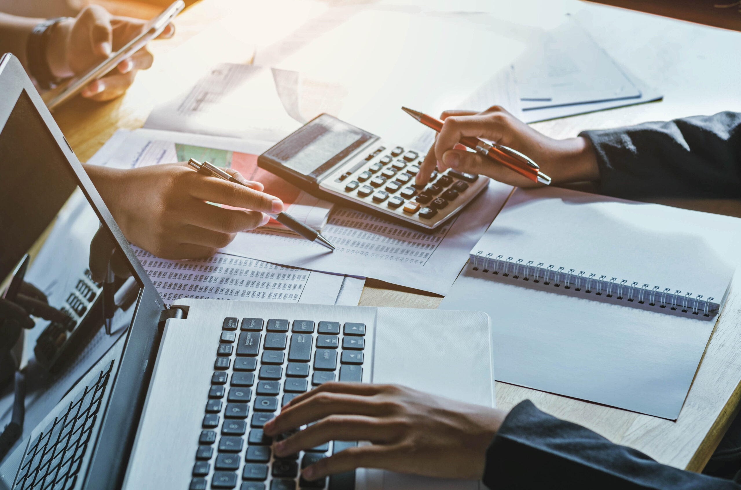 Valuations 6 Mensen die werken met een computer en een rekenmachine.