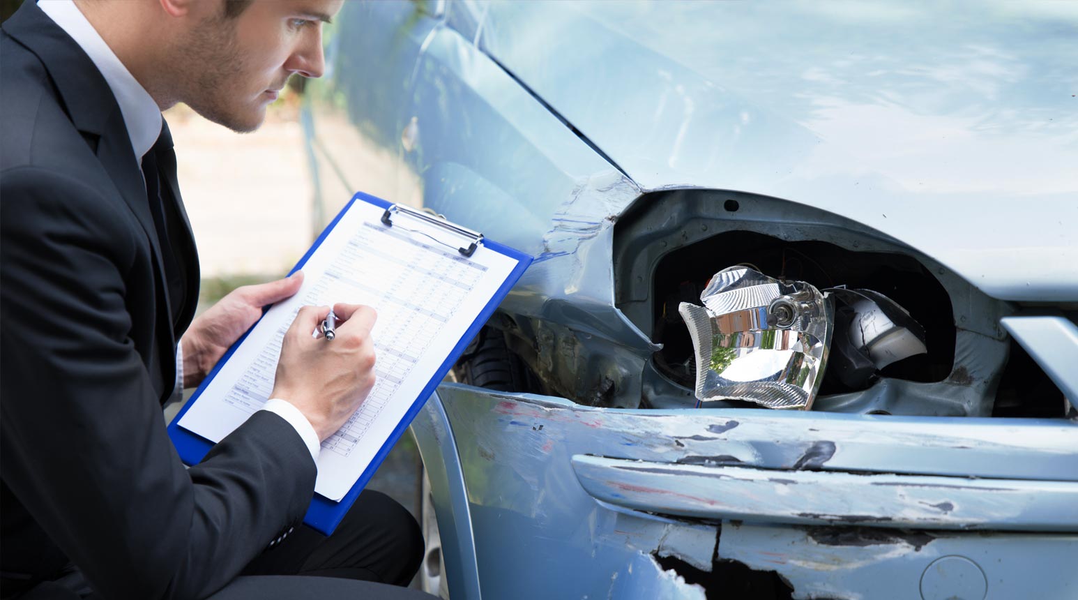 Appraisals 2 A man performing an auto appraisal.
