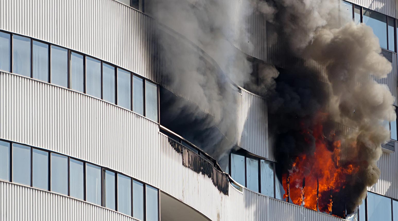 Commercial 1 Smoke and fire on the outside of a commercial building.