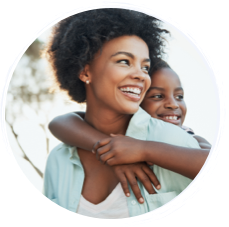 Woman and her son smiling.